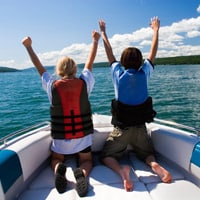 kids riding in recreational boat