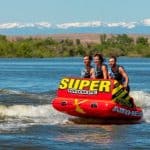 Three tubers ride chariot style on the Super Mable towable tube from airhead